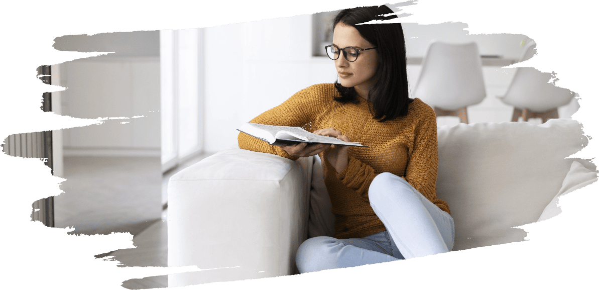 young woman reading from book home 1